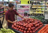 Mohamed Ali, one of the store's managers, checks on an impressive display of fruits and vegetables in the recently opened Lemoore Food Center.